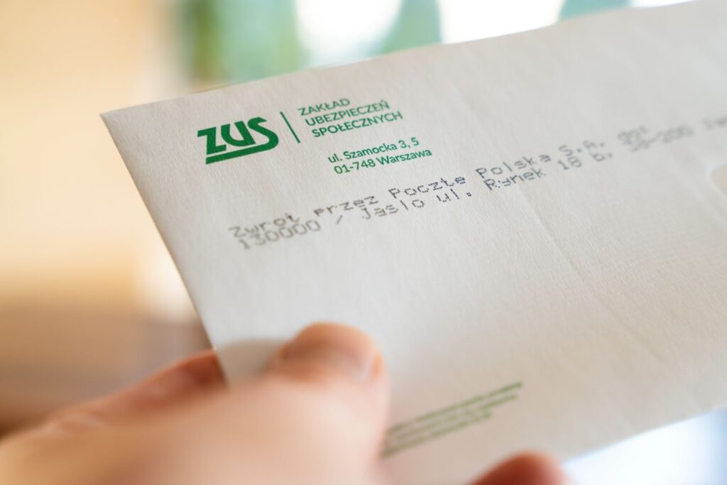Człowiek trzymający list z ZUS, koperta